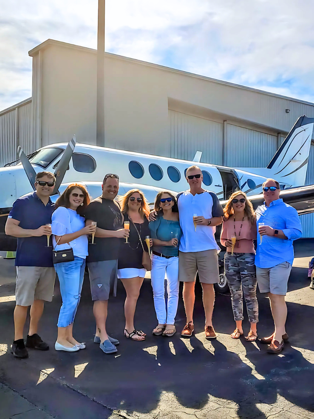 Passengers boarding a KW private flight at sunset